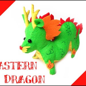May include: A green felt plush toy dragon with orange and red accents. The dragon has a long snout, large eyes, and a long tail. The toy is labeled "Eastern Dragon".