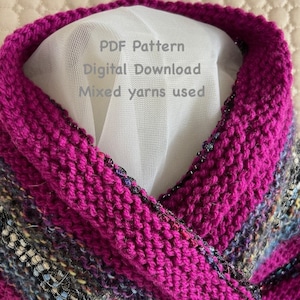 May include: A close-up of a knitted cowl in a deep purple colour with a multi-coloured stripe pattern. The cowl is made with mixed yarns and is available as a PDF pattern digital download.