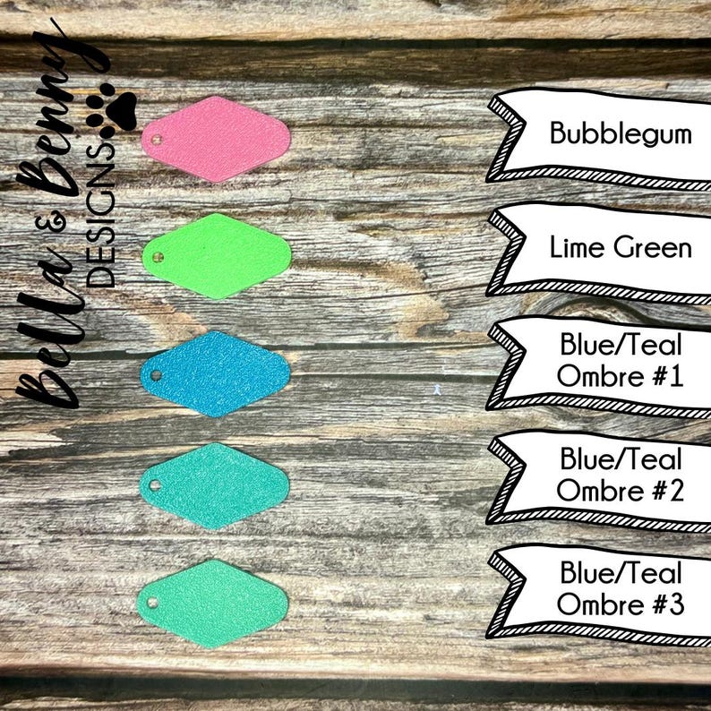 May include: Five diamond-shaped leather keychains in different colors: bubblegum pink, lime green, teal blue, turquoise blue, and a lighter teal green. The colors are labeled below each keychain.