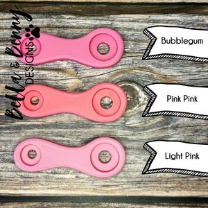 May include: Three pink plastic rings with different shades of pink. The rings are labeled "Bubblegum", "Pink Pink", and "Light Pink".