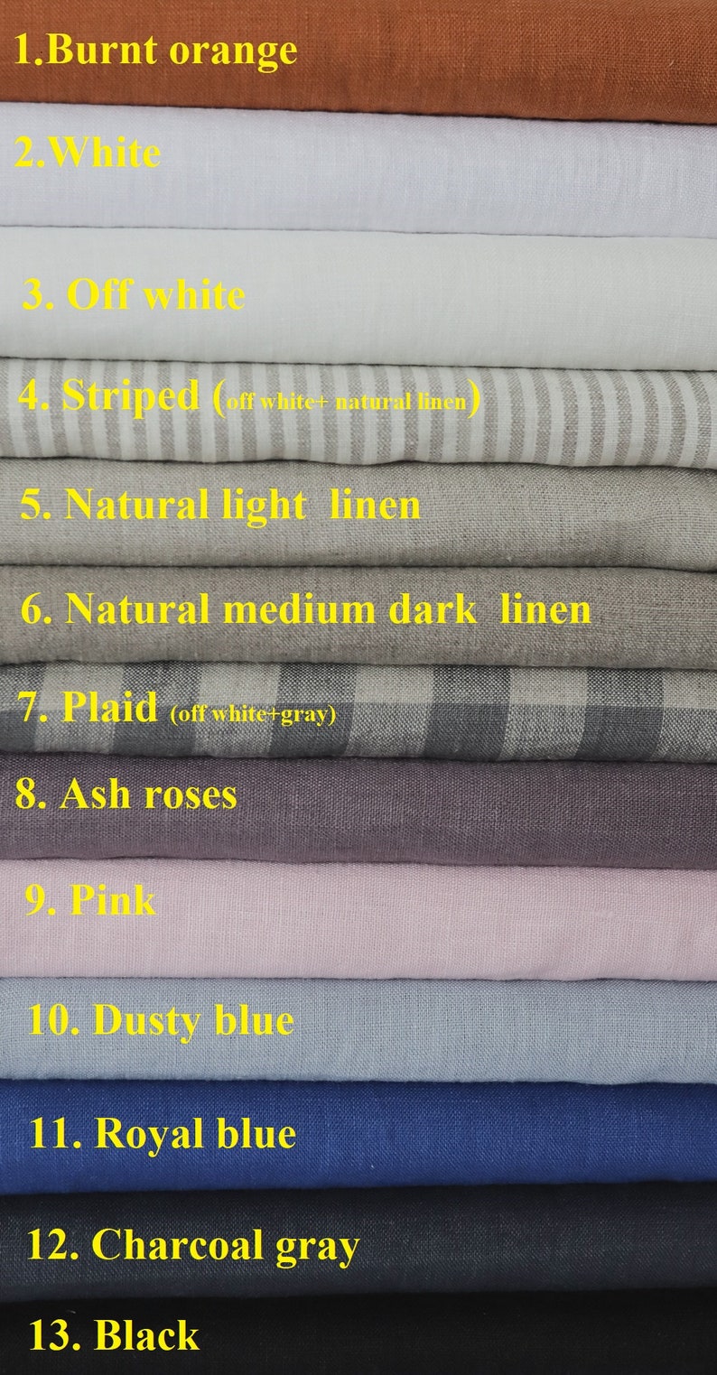 May include: A stack of 13 fabric swatches in various colors, including burnt orange, white, off-white, striped, natural linen, plaid, ash rose, pink, dusty blue, royal blue, charcoal gray, and black.