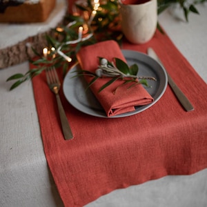 European linen table runner with ceramic mug and greenery
