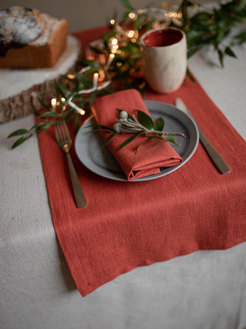 European linen table runner with ceramic mug and greenery