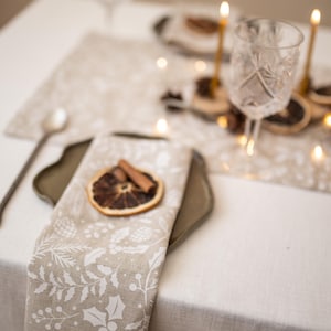 Handmade Christmas linen cotton cloth napkins with Winter Holly sprigs print for holiday hosting decor