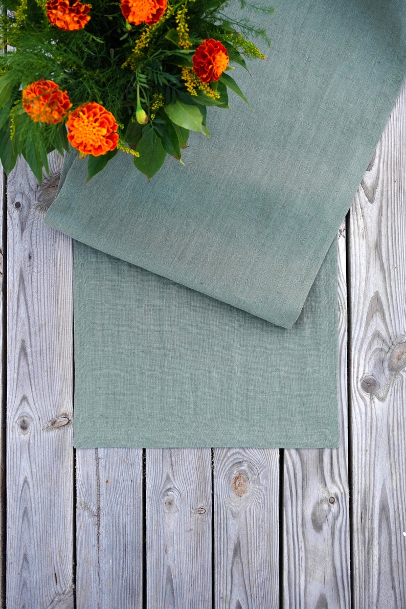 Stone washed sage green linen table runner styled for a modern farmhouse dining table