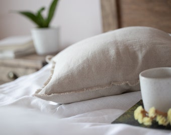 Natural linen pillowcases with fringe. Bed linen pillow cover with fringes. Throw pillow with frayed edge for rustic home decor.