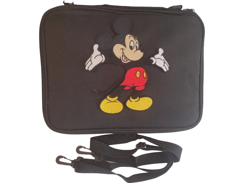 May include: Black rectangular bag with a zipper closure and a detachable shoulder strap. The bag features an embroidered image of Mickey Mouse in his classic outfit: red shorts, yellow shoes, and white gloves.