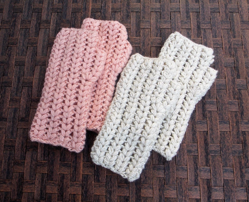 2 pairs of hand/arm warmers in the colors cream and pink.