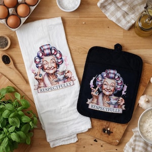 May include: A white tea towel and a black oven glove with a comical illustration of an elderly woman with curlers, holding a teacup and giving the middle finger. The text "RESPECTFULLY" is below the image.