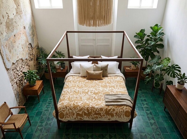 May include: A wooden four-poster bed frame centered in a room with green tiled flooring. The bed features a mustard yellow patterned quilt, white and tan pillows, and a gray throw blanket. Several potted green plants surround the bed frame.