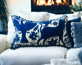 Royal blue rectangular Otomi pillow case with pom poms