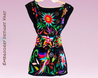 May include: A black sleeveless dress with colorful embroidery featuring flowers, birds, and butterflies. The embroidery is done in a variety of colors, including red, yellow, green, blue, and purple.