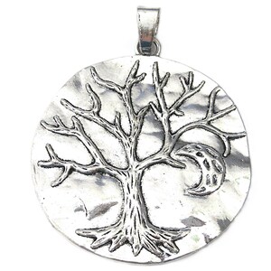 May include: Silver-toned pendant featuring a tree design with a crescent moon. The tree has detailed branches and roots, set against a textured, circular backdrop. The pendant includes a loop for a chain.
