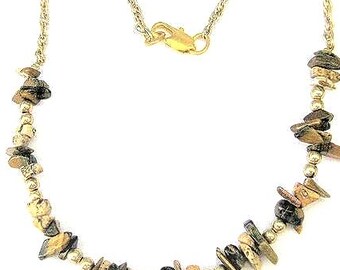 May include: A gold-toned necklace with a delicate chain and a lobster clasp. The necklace features small, round beads interspersed with irregularly shaped, earthy-toned stones, creating a natural, organic aesthetic. The necklace is displayed against a white background.