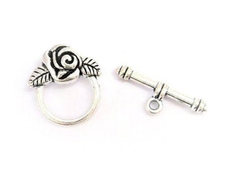 May include: Silver-toned rose flower toggle clasp with a bar and loop closure. The rose has detailed petals and leaves.