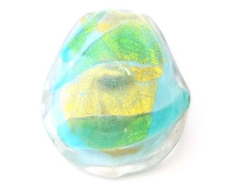 May include: A clear glass bead with swirls of blue and green, accented with gold foil.