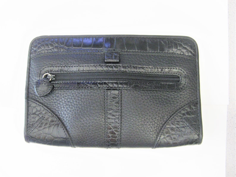 May include: Black leather clutch with a crocodile embossed pattern and a zippered pocket.