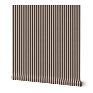 May include: A roll of wallpaper featuring a vertical stripe pattern. The stripes alternate between a light beige and a dark brown color. The wallpaper is partially unrolled, revealing the pattern and texture.