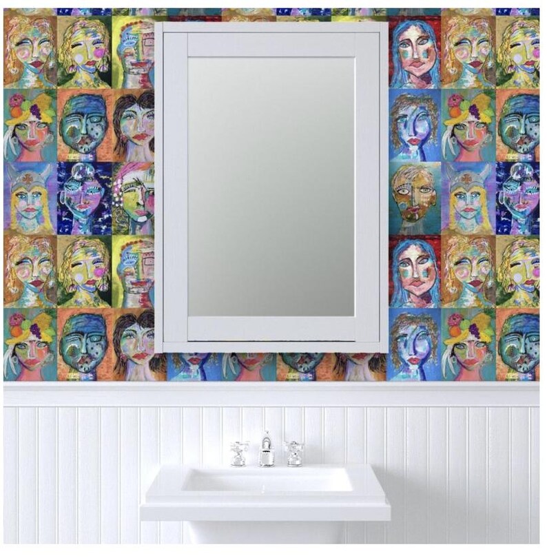 May include: A white bathroom vanity with a medicine cabinet above the sink. The walls are covered in colorful wallpaper with a pattern of painted faces.