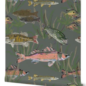 May include: Wallpaper featuring a repeating pattern of various fish in shades of green, yellow, orange, and pink against a dark gray background. The design includes stylized aquatic plants, creating an underwater scene.