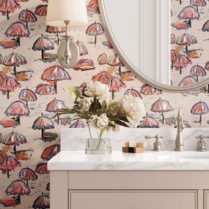 May include: A bathroom vanity with a white marble countertop and a beige cabinet with two drawers. The vanity is decorated with a floral arrangement in a clear glass vase. The wall behind the vanity is covered in wallpaper with a pattern of colourful umbrellas.