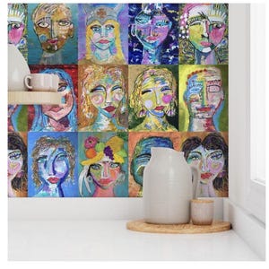 May include: A colorful wall mural featuring a grid of 12 abstract faces painted in bright colors. The faces are all different shapes and sizes, and they have a variety of expressions. The mural is a unique and eye-catching piece of art.