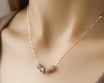 Minimalist silver bead necklace with coiled metal beads on a sterling silver chain — lightweight, modern,  layering or everyday wear