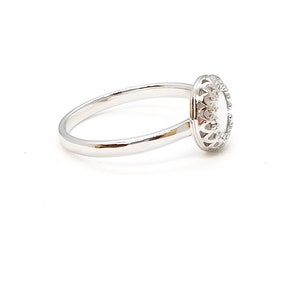 May include: A silver ring featuring a white oval stone set within an ornate filigree design.