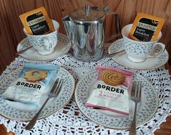 A pair of Queen Anne vintage trio sets with teaspoons and cake forks.