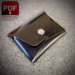 May include: A black leather wallet with a flap closure and a silver button. The wallet is folded in half and has a smooth, shiny finish.