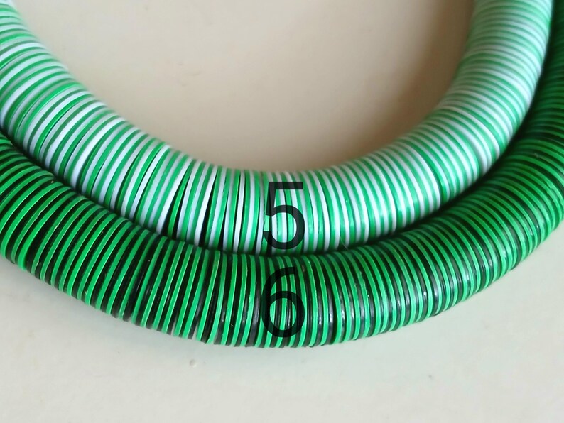 May include: Two green and white striped hoses with black accents. The hoses are coiled and labeled with the numbers 5 and 6.