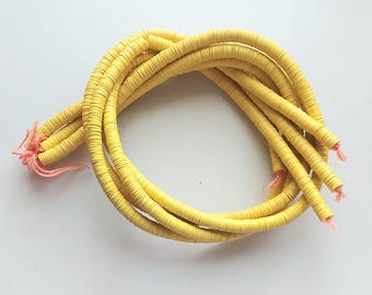 10 mm. yellow African vulcanite vinyl heishi beads, strand 80 cm. (32 inches)