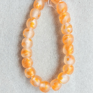 21 African recycled glass beads, (14 mm diam.), strand 10 inches, clear glass mottled orange