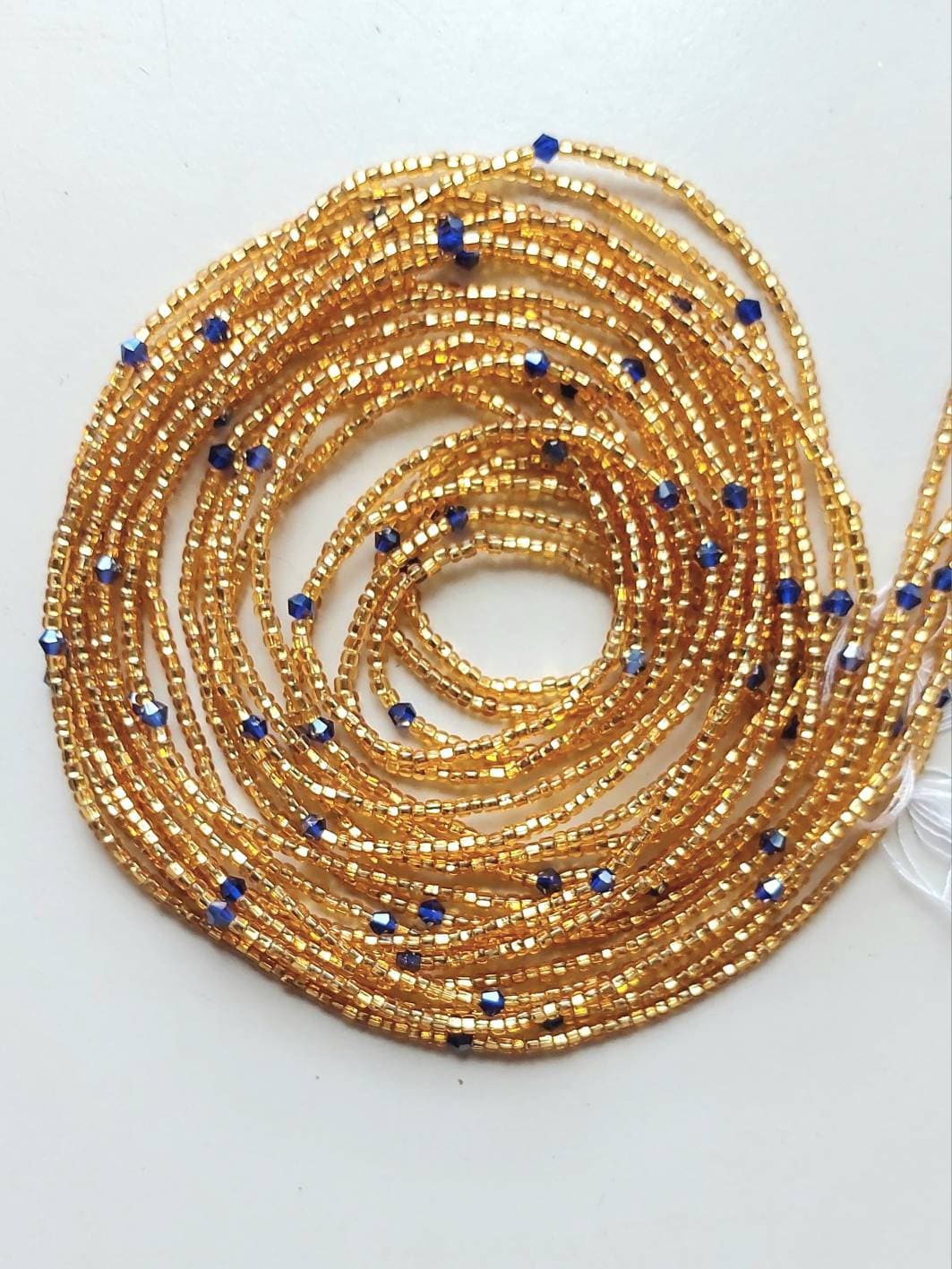 African waist beads, tie on, strand 42/44 inches, 108/112 cm., gold seeds with blue crystals