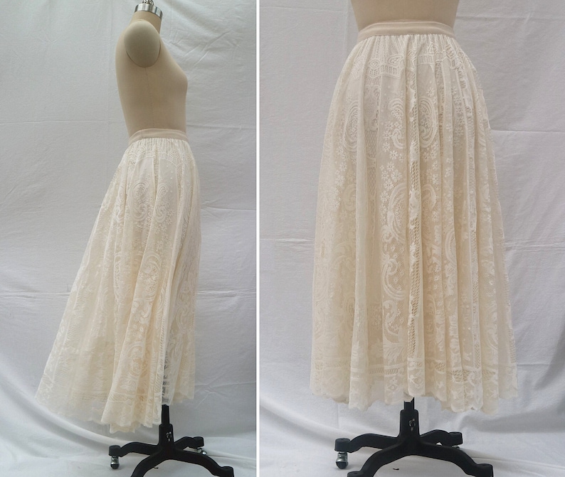May include: A white lace skirt with a delicate floral pattern. The skirt is full and flowing, and it has a waistband.