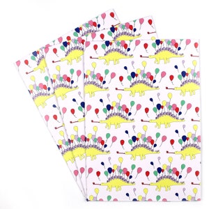 May include: A pack of four wrapping paper sheets featuring a repeating pattern of yellow dinosaurs with purple, pink, red, blue, and green balloons. The dinosaurs are blowing party horns.