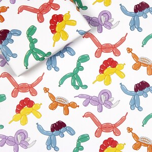 May include: A white background with a repeating pattern of colorful balloon animals. The balloon animals are shaped like dinosaurs, turtles, and elephants. The colors include red, orange, yellow, green, blue, and purple.