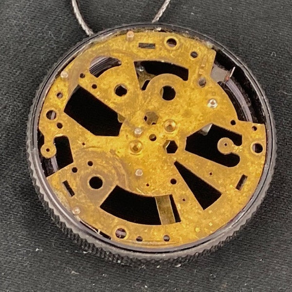 Doublesided pendant clock part inside repurposed camera lens