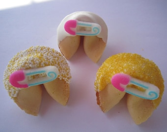 May include: Three fortune cookies decorated with white and yellow sprinkles and a pink and blue baby safety pin.