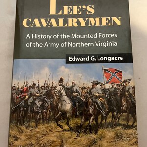 May include: A hardcover book titled "Lee's Cavalrymen" with a historical painting of mounted soldiers on the cover. The book's title and author's name are in gold lettering against a dark background. The cover art depicts a battle scene.