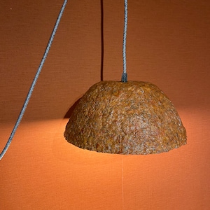 Handmade pendant light made from recycled brick-colored papier-mâché