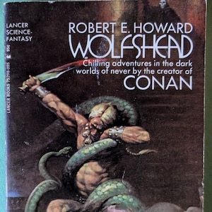 May include: A set of three ceramic mugs with a speckled, cream-colored glaze. Each mug features a different hand-painted design: a blue and green leaf, a yellow flower, and a red berry. The mugs have a simple, modern design.
