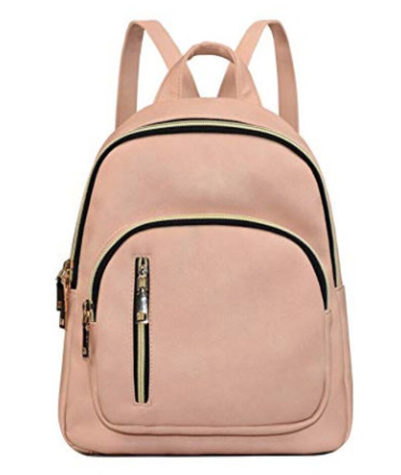 May include: A light pink faux leather backpack with black and gold zipper accents. The backpack has a front pocket with a zipper.