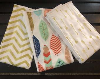 Gold and white baby girl burp cloths in shimmer gold arrows, zig zag, and dots