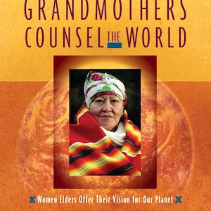 May include: Book cover titled "Grandmothers Counsel the World" with text and an image of an older woman wearing a headscarf and shawl. The author is Carol Schaefer. The cover has a warm, orange and yellow color scheme.