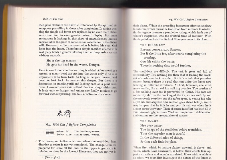 May include: Open book pages with text and a Chinese symbol. The text discusses religious attitudes and the Book of Changes. The pages are yellowed, suggesting age. The book is likely a guide or commentary.