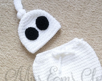 Puede incluir: Disfraz de fantasma blanco de crochet para bebé, con un gorro con dos ojos negros y un cuerpo a juego con cola.