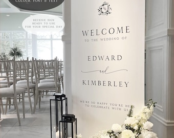 May include: White wedding welcome sign with black text. The sign reads "Welcome to the wedding of Edward and Kimberley. We're so happy you're here to celebrate with us."