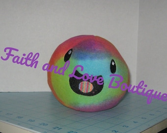 May include: A rainbow tie-dye plush toy with a smiling face and a large, colorful mouth. The toy is made of soft, fuzzy fabric and has a cheerful expression.