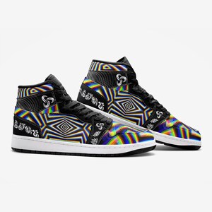 May include: A pair of black high-top trainers with a colourful, psychedelic pattern. The pattern features rainbow stripes, geometric shapes, and a white swirl design. The trainers have a white sole and black laces.